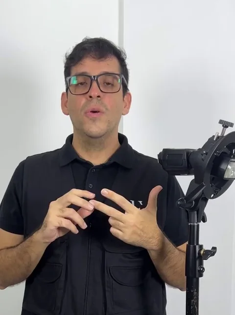 Elías con su remera negra explicando junto a una luz de estudio